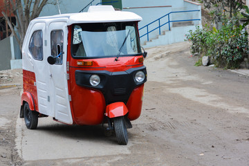 White and red mototaxi on the road. © ruslanita