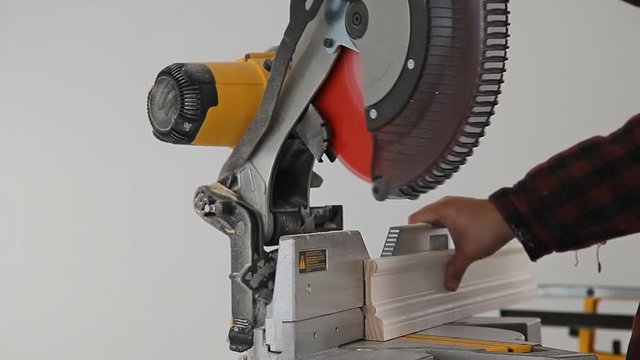 Contractor Using Circular Saw Cutting Crown Moulding for Renovation.