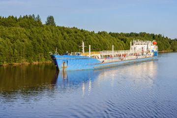 Fototapeta na wymiar The tanker near the shore of the river