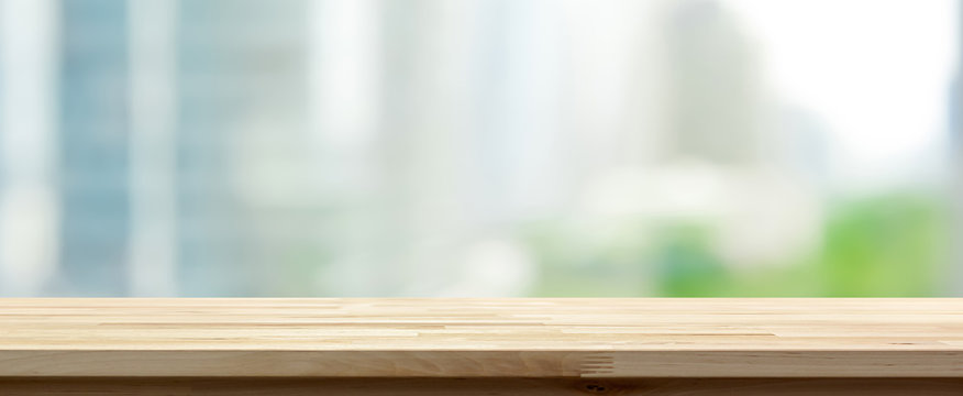 Wood table top on abstract blurred cityscape background