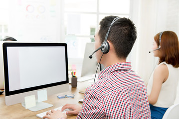 Back view of  telemarketing customer service agent team working in call center
