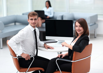 smiling member of the business team sitting at Desk