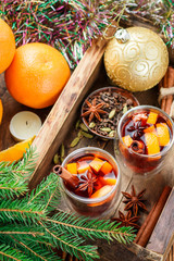 Mulled wine - Christmas hot drink with orange, cinnamon, cardamom and anise in a glass cups. New year. Selective focus