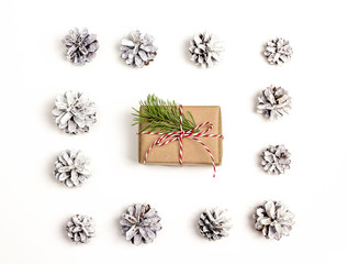 Christmas background with gift box and pine cones. Flat lay.