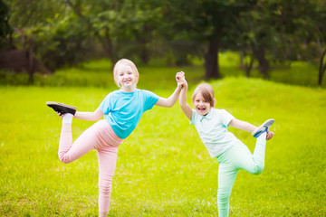 Two school girls doing exercises.