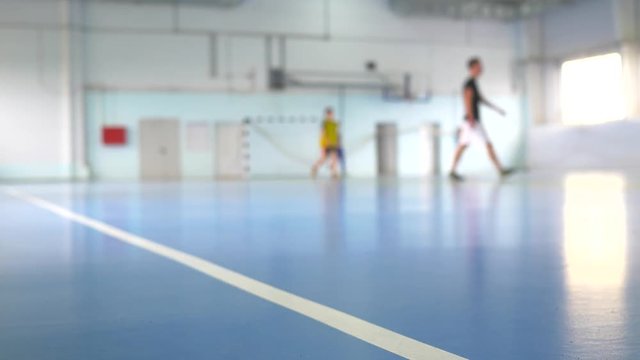 Football futsal training for children. Indoor soccer young player with a soccer ball in a sports hall.