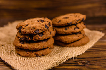 Chocolate chip cookies on sackcloth on a wooden table