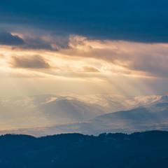Rays of light pass through the clouds, mountain landscape