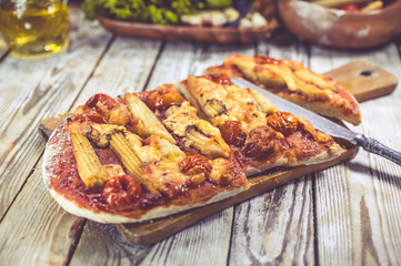 Vegetarian pizza on a wooden table. Traditional Mediterranean cuisine. Selective focus