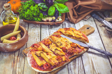 Vegetarian pizza on a wooden table. Traditional Mediterranean cuisine. Selective focus