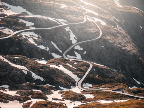 Kurvige Passstra&szlig;e vor dem Trollstigen in Norwegen mit einscheinendem Sonnenlicht