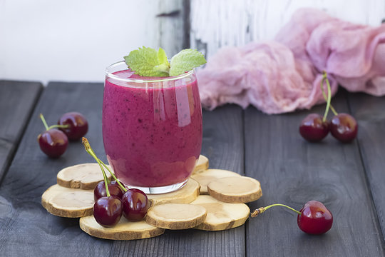 Berry smoothie on a dark wooden background.
