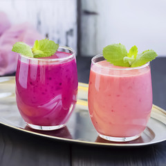 Berry smoothie on a dark wooden background.