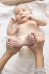 Mother happily playing with her baby after having bathed