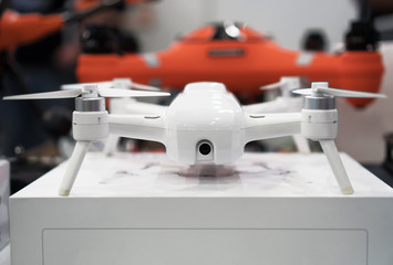 Modern white drone with 4k camera in the store. - obrazy, fototapety, plakaty