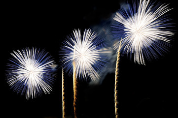 Flashes of fireworks of white and blue color