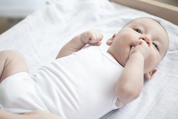 Mother happily playing with her baby after having bathed