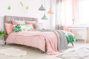 Bed with pastel pink bedding - obrazy, fototapety, plakaty