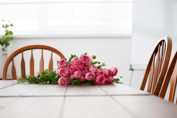 White table with bouquet of pink peonies