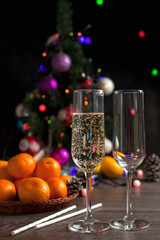 traditional New Year's table, tangerines, champagne, Christmas tree and New Year's lights