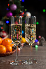 traditional New Year's table, tangerines, champagne, Christmas tree and New Year's lights