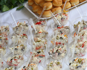 plastic bowls with rice salad during reception