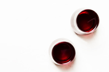 Dry red wine in glasses on a white background, top view