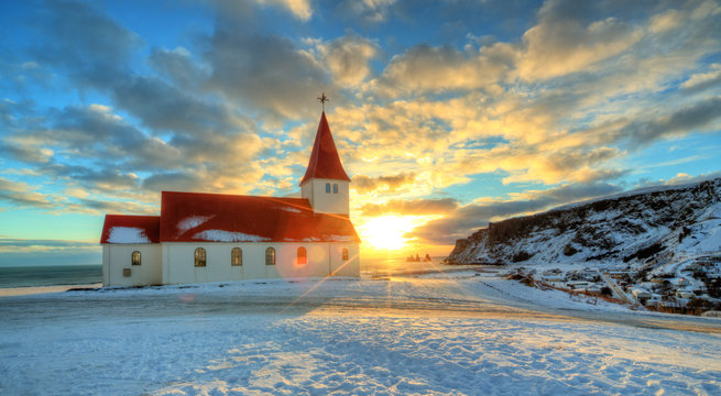 Typical red colored wooden church in Vik town, Iceland