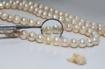 bad rotten tooth pulled out and is opposite the dental mirror and dazzling pearls