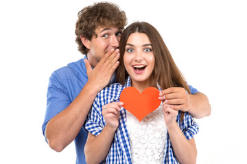Secret. Young loving couple holding in their hands red hearts, a symbol of love. Valentine's Day.
