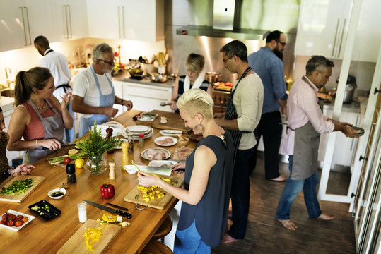 Group Of Friends Are Cooking In The Kitchen