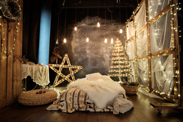 christmas studio decoration with vintage lightbulbs, wooden star and a lot of lights