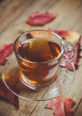 Cup of tea on the rustic background with autumn decoration. Selective focus. Shallow depth of field.