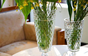 A vase and plant of the glass on the table of the room