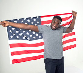 Handsome afro american man with united states flag in hands. Smiling face. Successful confident patriotic male.
