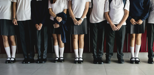 Group of students standing in the row - obrazy, fototapety, plakaty