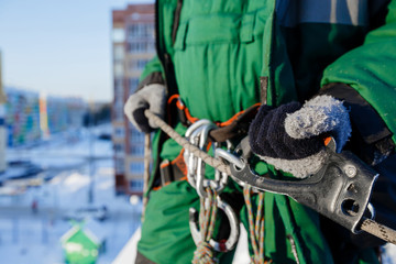 Close-up of safety belt and carbine, concept of cleaning roofs from snow in winter
