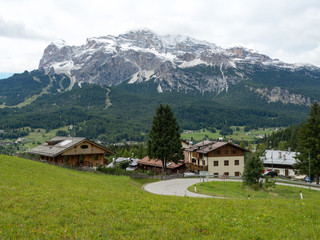 A beautiful view of the Italian Alps. Green grass, mountains and sky with clouds. Dolomiti, autumn 2017
