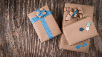 Three handcraft gift boxes on vintage wood