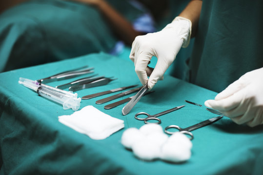 Doctor preparing medical tools for operation