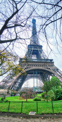Fototapeta na wymiar Skyward view of Eiffel Tower on a cloudy winter day - France