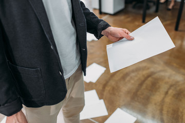 croped shot of businessman holding blank paper