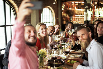 Friends taking a selfie at a dinner party