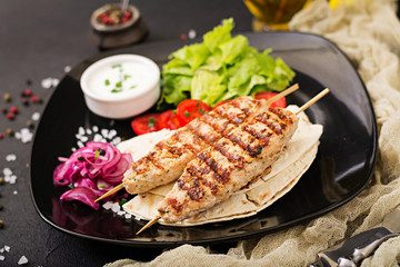 Minced Lula kebab grilled turkey (chicken) with fresh vegetables.