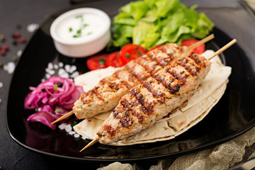 Minced Lula kebab grilled turkey (chicken) with fresh vegetables.