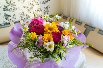 Bouquet of flowers on table in the room