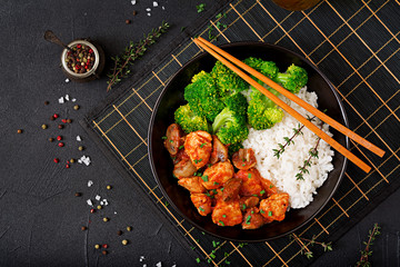 Pieces of chicken fillet with mushrooms stewed in tomato sauce with boiled broccoli and rice. Proper nutrition. Healthy lifestyle. Dietetic menu. Top view
