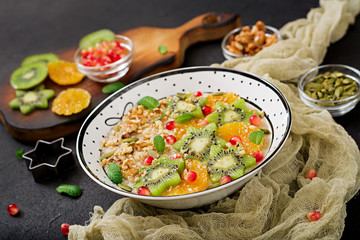 Tasty and healthy oatmeal porridge with fruit, berry and nuts. Healthy breakfast. Fitness food. Proper nutrition