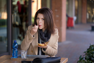 young beautiful woman having break at cafe