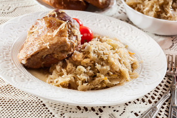 Pork knuckle with fried sauerkraut and tomatoes